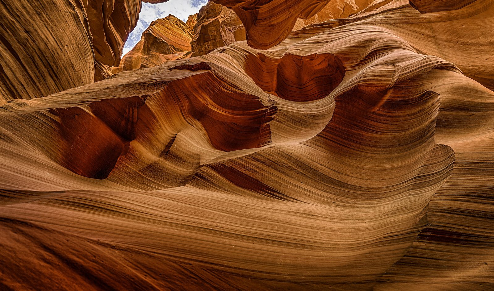 Antelope Canyon X: an opening to the sky between the walls